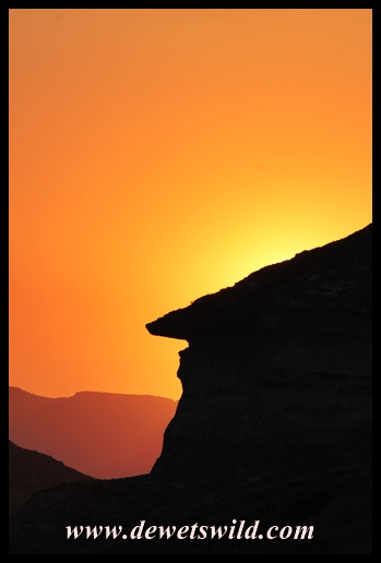 The sun setting behind the mushroom rocks